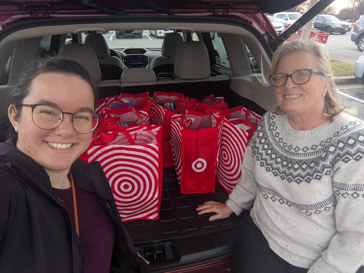 Department of Community Resources and Services pose with Target bags filled with donations for Project Holiday.